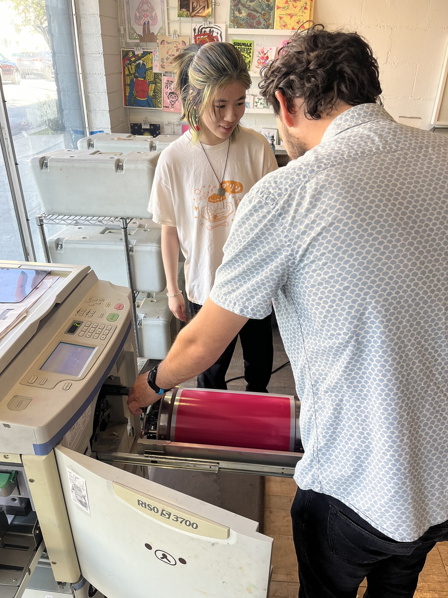 Swapping a pink drum in a Risograph