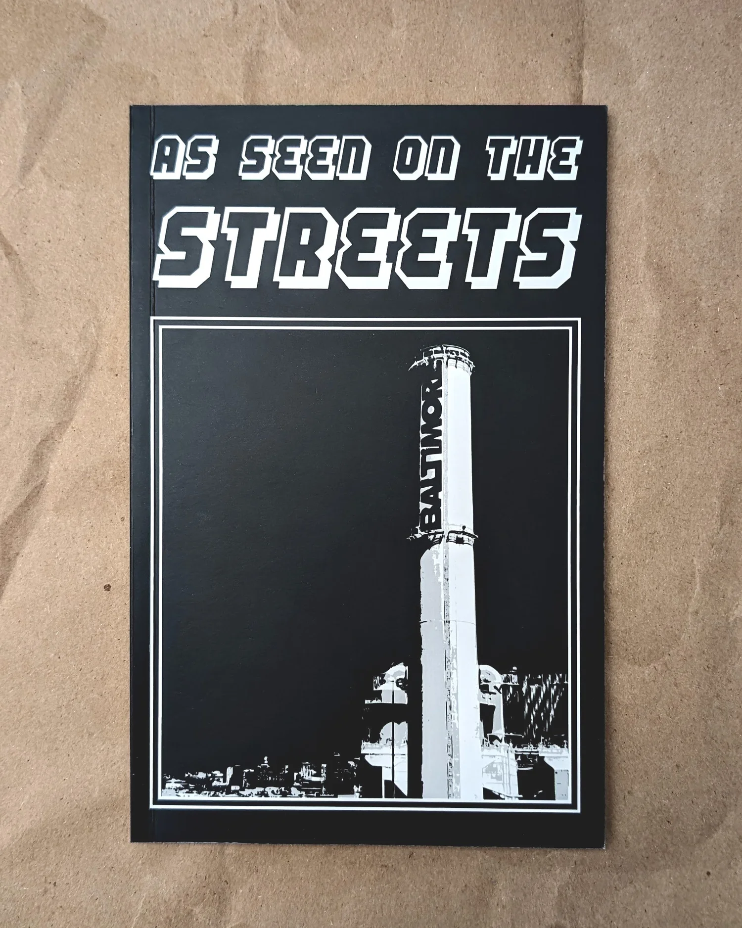 Zine cover: AS SEEN ON THE STREETS, white type and a smokestack on black