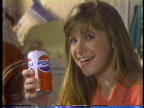 A teenage girl holding a can of Pepsi